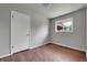 This cozy bedroom features hardwood floors, neutral gray walls, and a classic white door at 426 Kenton St, Aurora, CO 80010