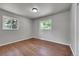 Bright bedroom with hardwood floors and two windows offering plenty of natural light at 426 Kenton St, Aurora, CO 80010