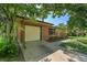 A brick and siding home featuring a concrete driveway and an attached single-car garage at 426 Kenton St, Aurora, CO 80010