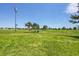 Expansive green space offers a serene view with multiple trees and open grassland at 426 Kenton St, Aurora, CO 80010