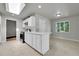 Well-lit kitchen with modern appliances, white cabinets, and an adjacent breakfast nook at 426 Kenton St, Aurora, CO 80010