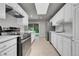 Bright kitchen with stainless steel appliances and white cabinetry providing a modern touch at 426 Kenton St, Aurora, CO 80010