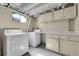 Functional laundry room with washer, dryer, cabinets and counter space at 426 Kenton St, Aurora, CO 80010
