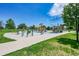 Playground and exercise area with a variety of equipment and lush green landscaping at 426 Kenton St, Aurora, CO 80010