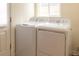 Well-lit laundry room featuring a modern washer and dryer with convenient access at 740 S Shoshone St, Denver, CO 80223