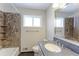 Well-lit full bathroom features tiled shower, granite countertop, and updated fixtures at 10799 Murray Dr, Northglenn, CO 80233