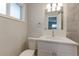 Bright bathroom with a vanity with a white countertop and cabinet, tile floor, and modern fixtures at 10799 Murray Dr, Northglenn, CO 80233