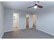 Neutral bedroom features carpet floors, ceiling fan, access to a bathroom and a closet at 10799 Murray Dr, Northglenn, CO 80233