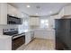 Updated kitchen with stainless steel appliances, white cabinets, and light countertops at 10799 Murray Dr, Northglenn, CO 80233