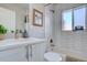 Modern bathroom with white hexagon tile, a soaking tub, and updated vanity at 3430 N Cook St, Denver, CO 80205