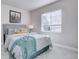 Bright bedroom with a gray bed and teal accents at 3430 N Cook St, Denver, CO 80205