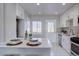 Modern kitchen with white cabinets, stainless steel appliances, and an island at 3430 N Cook St, Denver, CO 80205