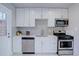 White kitchen with stainless steel appliances and subway tile backsplash at 3430 N Cook St, Denver, CO 80205