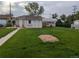 Spacious backyard with lush green grass, a shed, and a covered carport at 1009 Bush St, Brighton, CO 80601