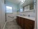 Bright bathroom featuring a vanity, large mirror, and a combined tub and shower at 1009 Bush St, Brighton, CO 80601