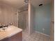 Simple bathroom with a vanity, walk-in shower with glass doors, and tiled floor at 1009 Bush St, Brighton, CO 80601