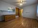Bedroom with wood floors, wardrobe, and large windows for natural light at 1009 Bush St, Brighton, CO 80601