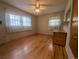Bedroom with hardwood floors and large windows allowing for natural light to fill the room at 1009 Bush St, Brighton, CO 80601