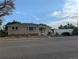 Charming single story home with brick accents and manicured front yard landscaping at 1009 Bush St, Brighton, CO 80601