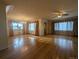 Spacious living room featuring gleaming hardwood floors and abundant natural light at 1009 Bush St, Brighton, CO 80601