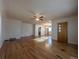 Bright, open-concept living room with gleaming hardwood floors and ceiling fan at 1009 Bush St, Brighton, CO 80601