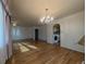 Charming living room with beautiful hardwood floors and decorative chandelier lighting at 1009 Bush St, Brighton, CO 80601