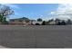 Street view of home with detached carport and fenced yard with mature trees at 1009 Bush St, Brighton, CO 80601
