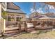 A backyard deck with outdoor seating is ideal for entertaining and enjoying the green lawn with privacy fencing at 14023 W Amherst Pl, Lakewood, CO 80228