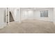 Large finished basement area with new carpeting, stairs, and bathroom, providing ample living and storage space at 14023 W Amherst Pl, Lakewood, CO 80228