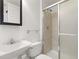 This bathroom features a single sink vanity, tiled shower, and white fixtures for a clean and modern look at 14023 W Amherst Pl, Lakewood, CO 80228