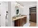 Bathroom features a double sink vanity with granite counters, warm wood cabinets, and modern fixtures at 14023 W Amherst Pl, Lakewood, CO 80228