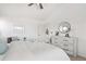 Bright bedroom with modern decor, featuring a vaulted ceiling, dresser, and lots of natural light at 14023 W Amherst Pl, Lakewood, CO 80228