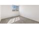 Cozy bedroom featuring a window, neutral carpet, and white walls offering a blank canvas at 14023 W Amherst Pl, Lakewood, CO 80228
