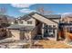 Inviting two-story home with a well-manicured lawn, a two-car garage, and a charming front porch at 14023 W Amherst Pl, Lakewood, CO 80228