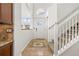 Bright foyer with tile flooring, a staircase, and a front door with transom window at 14023 W Amherst Pl, Lakewood, CO 80228