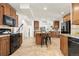 Spacious kitchen with cherry cabinets, granite countertops, an island, and stainless steel appliances at 14023 W Amherst Pl, Lakewood, CO 80228