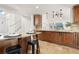 Bright kitchen featuring granite countertops, brown cabinets, and modern appliances at 14023 W Amherst Pl, Lakewood, CO 80228