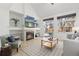 Inviting living room with a fireplace, built-in shelves, and a sliding door to the backyard at 14023 W Amherst Pl, Lakewood, CO 80228