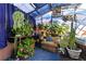 This sunroom is filled with plants and features comfortable seating for a bright and cozy space at 14023 W Amherst Pl, Lakewood, CO 80228