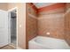 Bathroom featuring bath tub, shower, and tiled walls at 9039 E Panorama Cir # C204, Englewood, CO 80112