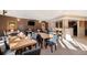 Community dining room includes long wooden tables, black chairs, and coffee and market posters at 9039 E Panorama Cir # C204, Englewood, CO 80112