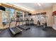 Bright fitness center featuring treadmills, elliptical machines, weight-training equipment, and large picture windows at 9039 E Panorama Cir # C204, Englewood, CO 80112