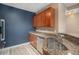 Well-equipped kitchen showcasing granite countertops, stainless steel sink, and custom cabinetry at 9039 E Panorama Cir # C204, Englewood, CO 80112