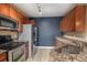 The kitchen features granite countertops, modern appliances, and sleek cabinetry at 9039 E Panorama Cir # C204, Englewood, CO 80112