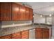 Kitchen featuring granite countertops, ample cabinet space, and a stainless steel sink at 9039 E Panorama Cir # C204, Englewood, CO 80112