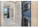 Laundry area shows modern washer and dryer and a doorway to another room at 9039 E Panorama Cir # C204, Englewood, CO 80112