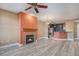 Open-concept living room with a fireplace that seamlessly transitions to the kitchen space at 9039 E Panorama Cir # C204, Englewood, CO 80112