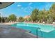 A refreshing swimming pool with lounge chairs and lush landscaping under a bright blue sky at 9039 E Panorama Cir # C204, Englewood, CO 80112