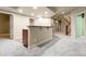 Open basement area with a stylish wet bar and staircase with beautiful wood railing at 2344 S Lupine St, Denver, CO 80228