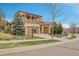 Charming home with a covered balcony, well-maintained lawn, and a three-car garage at 2344 S Lupine St, Denver, CO 80228
